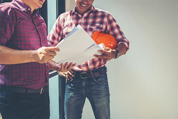 two men discussing work plans